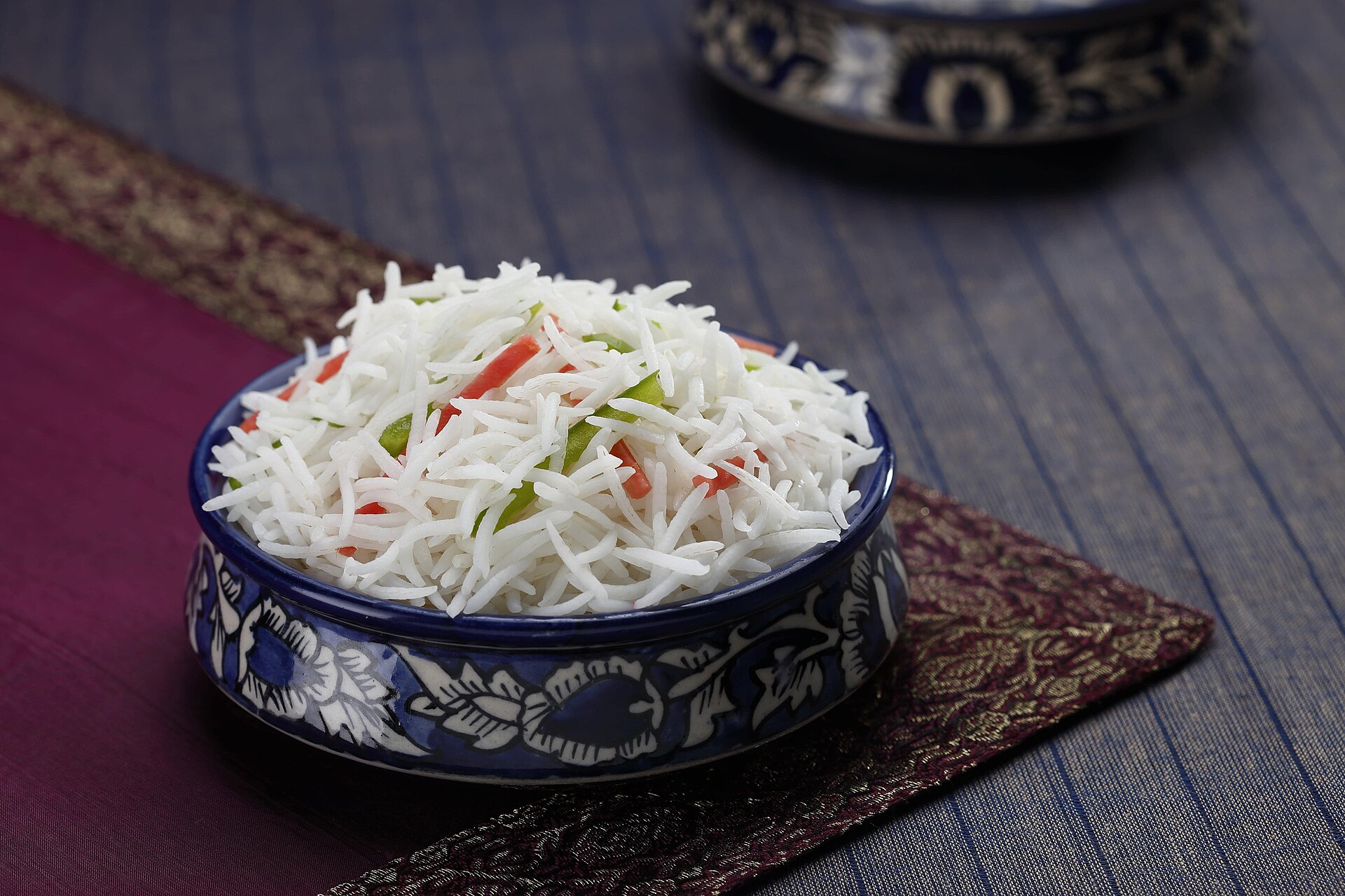 A bowl of cooked white rice on a table